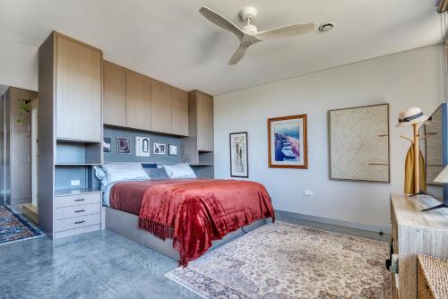 a bedroom with a bed and a ceiling fan at SALT Luxury Couples Villa in Venus Bay