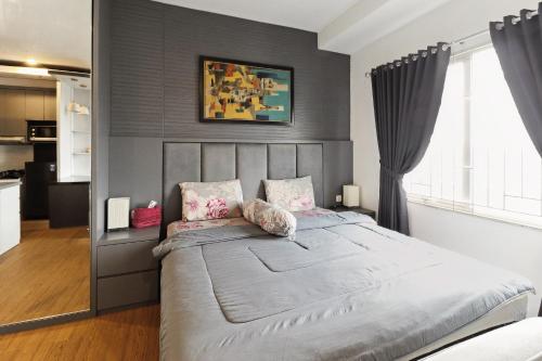 a bedroom with a large bed in a room at The Edge by Lia in Cimindi-hilir