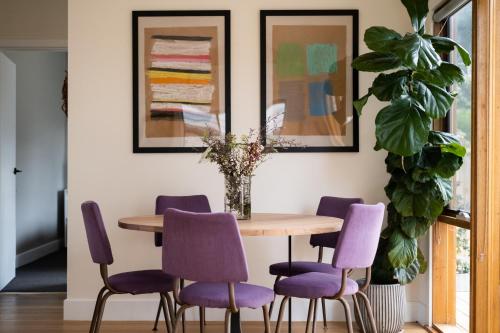a dining room with a table and purple chairs at Jujube in Dromana