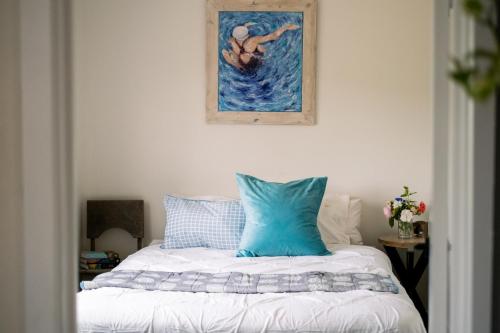 a bed with a blue pillow on top of it at Jujube in Dromana