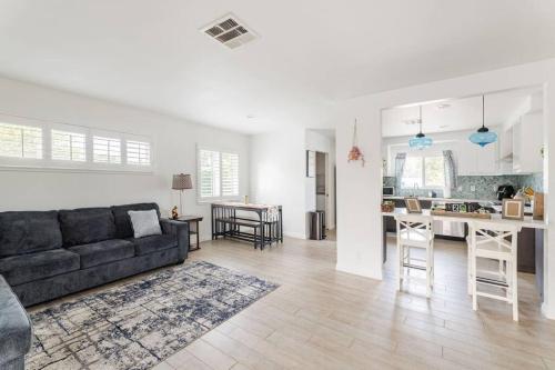 a large living room with a couch and a kitchen at Family Home by Disney+Knotts, Pool,Game Room in Fullerton