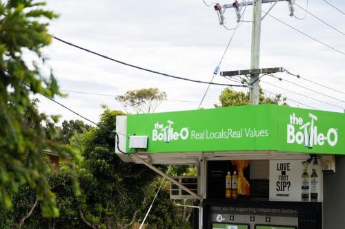 a gas station with a sign for the bubulco real reloaded mills at Jujube in Dromana