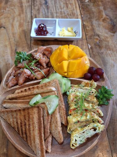 a plate of food with toast bread and other foods at Casas de Ruumar Bed and Breakfast-Bar-Two rooms for family available in Clarin