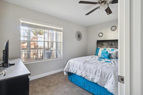 a bedroom with a bed and a ceiling fan at Center City Charm, the place to meet all of your needs in Huntsville
