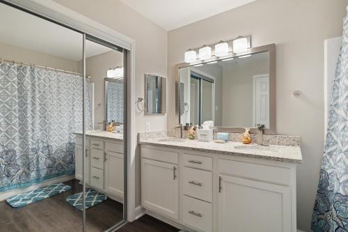 a bathroom with two sinks and a shower at Center City Charm, the place to meet all of your needs in Huntsville