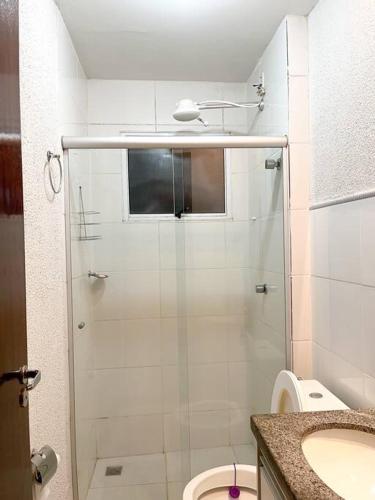 a bathroom with a shower and a toilet and a sink at home select apto inteiro 2 quartos Araguari in Araguari