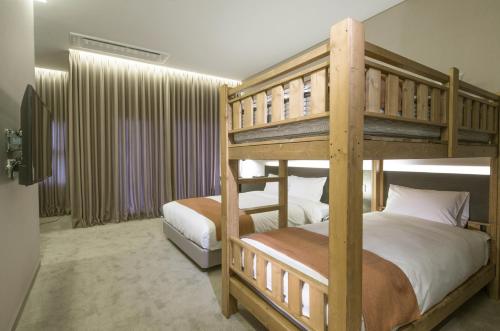 a bedroom with two bunk beds in a room at Grand Mer Hotel Seogwipo Ocean in Seogwipo