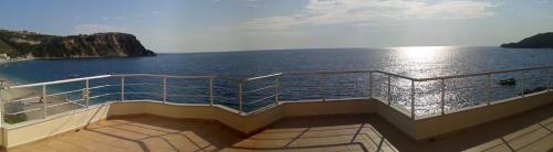 a balcony of a cruise ship looking at the ocean at Magic Ionian Apartments & Rooms in Himare