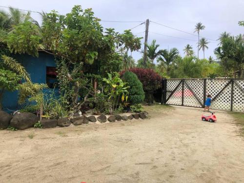 a red toy car parked in front of a house at FARE Tatahi in Parea