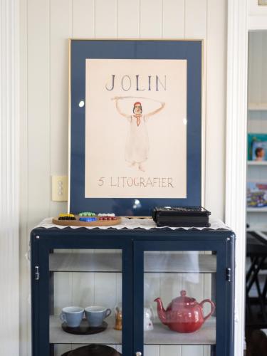 a blue cabinet with a picture on top of it at Heritage Queenslander Gem - Families & Groups - Minutes to CBD & South Brisbane in Brisbane