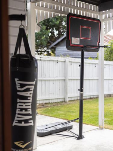 a basketball hoop on a stand in a yard at Heritage Queenslander Gem - Families & Groups - Minutes to CBD & South Brisbane in Brisbane