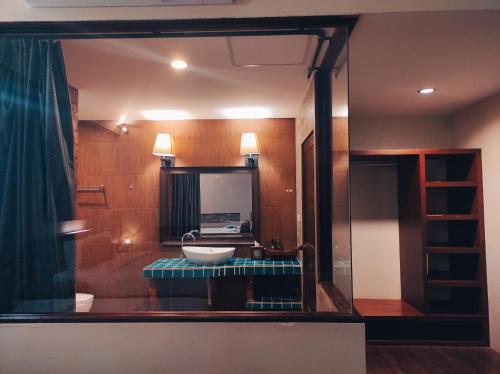 a bathroom with a sink and a mirror at Foresto Sukhothai Guesthome in Sukhothai