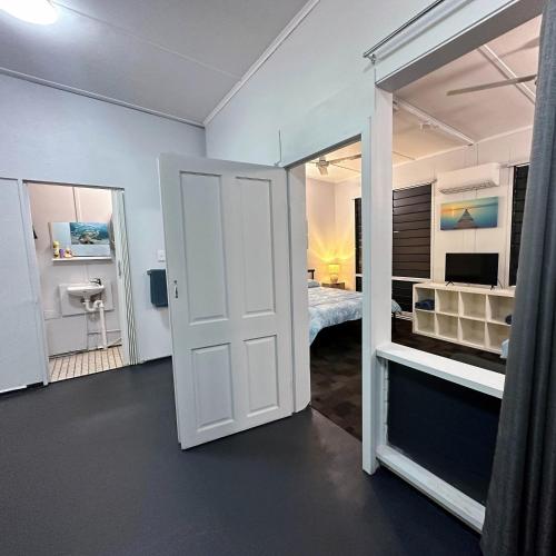 a room with a door leading to a bedroom at Unit 2 Golden Sands Retreat in Wagait Beach