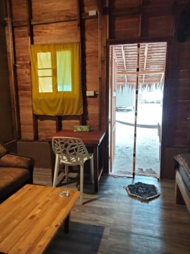 a living room with a couch and a table at Lazy Hut in Ko Phayam