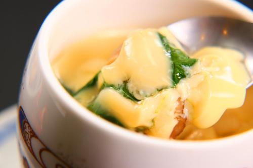 a cup of soup with a spoon in it at 民宿ふくだ in Minamiōsaka