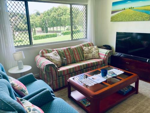 a living room with two couches and a coffee table at Central 3-Bedroom House with Garden in Mount Tamborine