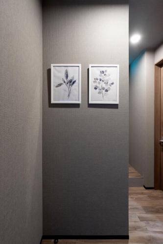 three framed drawings of flowers on a wall at 源泉かけ流し 白濁 Forest Suite Hakone Sengokuhara in Sengokuhara