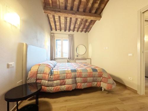 a bedroom with a bed with a table and a window at Casa Stefi Belfioreguesthouses in Pontedera