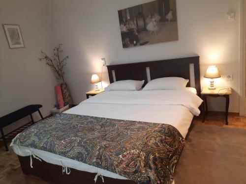 a large bed in a bedroom with two lamps at Lydia's City View Apartment in Ioannina