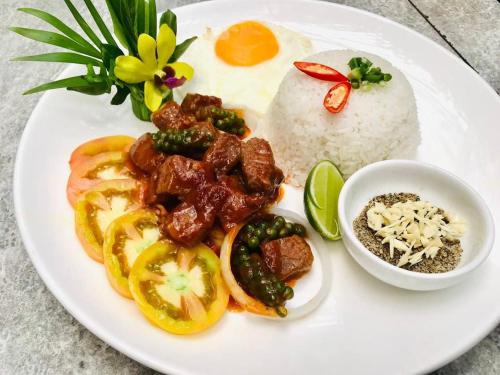 a plate of food with eggs and vegetables and rice at Green Valley Veal Pouch in Kampot