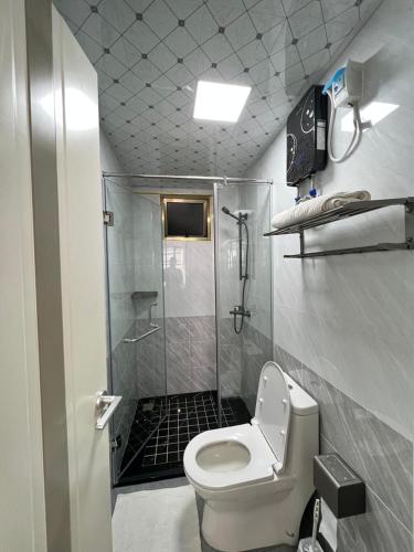a small bathroom with a shower and a toilet at Comfy studio near yaya Kilimani in Nairobi
