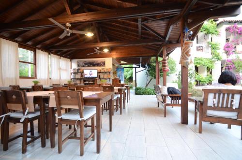 a dining room with wooden tables and chairs at Olive Garden Apart Hotel in Göcek