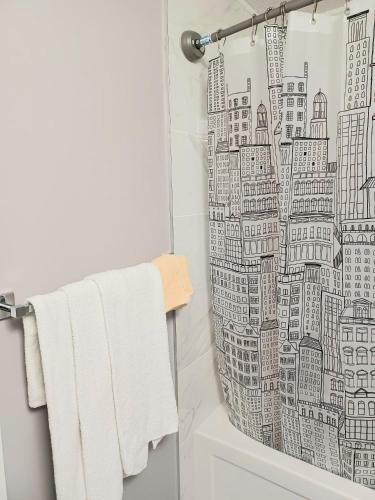 a shower curtain with a drawing of a city at Cozy Basement Suite - private entrance - Free Netflix in Edmonton