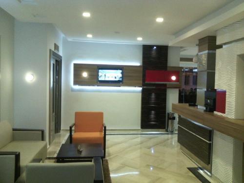 a living room with a couch and a tv at Marina Prestige Tabarka in Tabarka