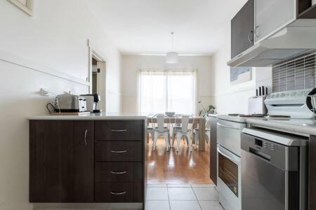 a kitchen with a sink and a counter top at Homely Cottage: Near the City Wifi & Parking in Newstead