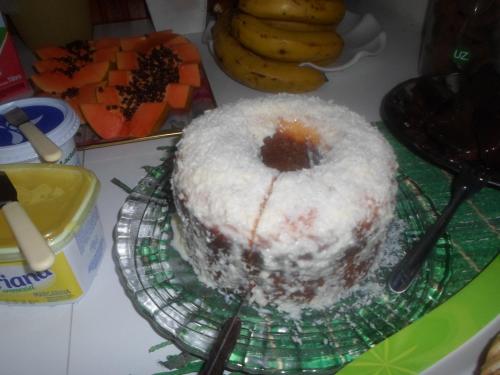 a cake sitting on a plate on a table at Pousada Laura / Ziza in Foz do Iguaçu