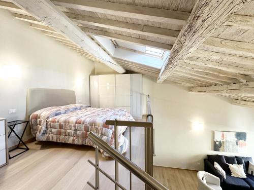 a loft bedroom with a bed and a skylight at Casa Lore in Pontedera
