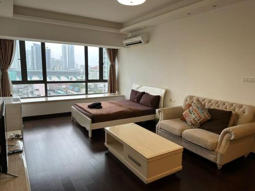 a living room with a couch and a coffee table at R&F Princess Cove @ R&F Mall in Johor Bahru