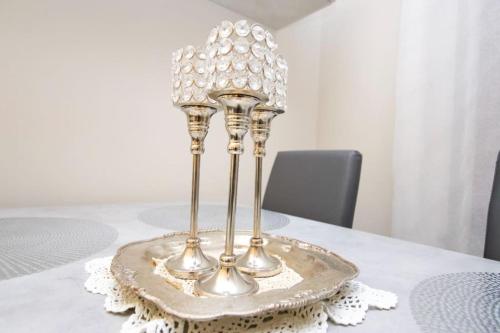 a table with a silver candle holder on a table at Comfort in Malpensa-Rho Fiera Milano 15 min in Legnano