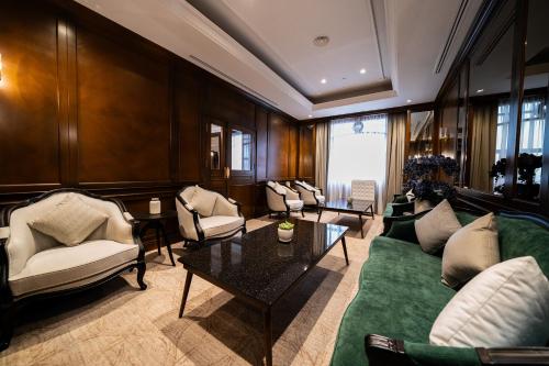 a living room with couches and a table at Renai Hotel Kota Bharu in Kota Bharu