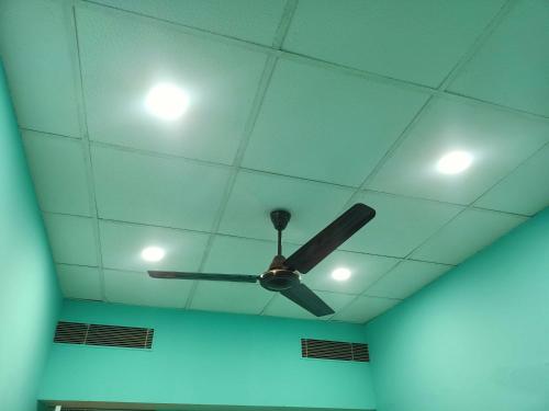 a ceiling with a ceiling fan and lights on it at Super OYO Flagship Sofitel Hotel in Dhanbād