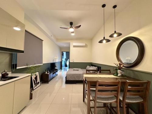 a kitchen and living room with a table and a bed at Paradigm Residence Studio 4pax 2King bed Netflix WiFi in Johor Bahru