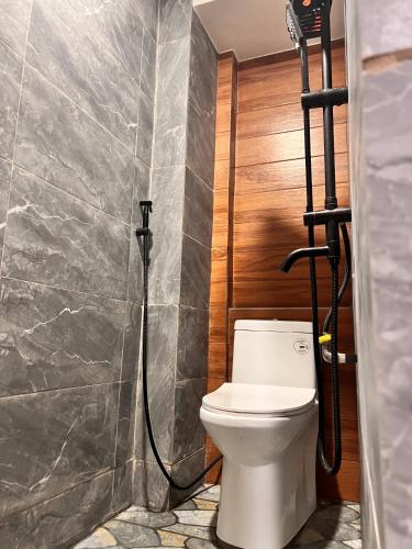 a bathroom with a toilet and a shower at Family House in Cagayan de Oro City in Cagayan de Oro