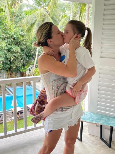 a man kissing a woman with a little girl at Plantation House in Hikkaduwa