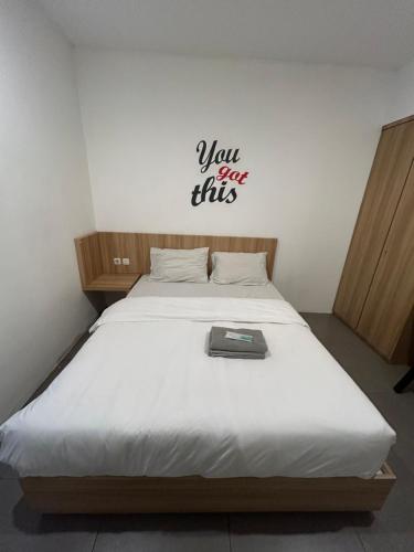 a bed with a sign that says you are this at Behomy Maxley Lippo Karawaci in Tangerang