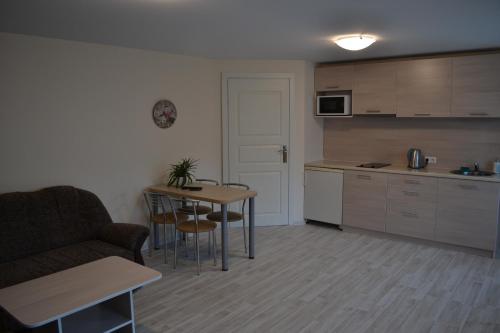 a kitchen with a couch and a table in a room at Apartamentai Vilma in Palanga