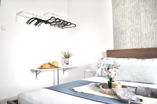 a bedroom with a bed with a tray of shoes on it at Varonos Summer Residences in Siviri
