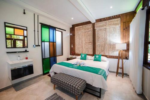 a bedroom with a bed and a sink in a room at Ubu Villa Ndalem Etnik at Prawirotaman Street in Yogyakarta