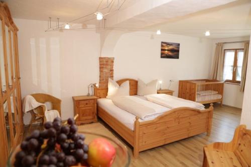 a bedroom with a bed and a table with fruit at Wolfeicherhof in Eggstätt