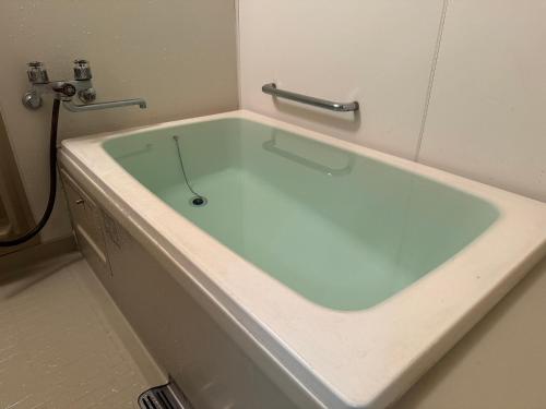 a large bath tub in a bathroom at Bandai in Tokamachi