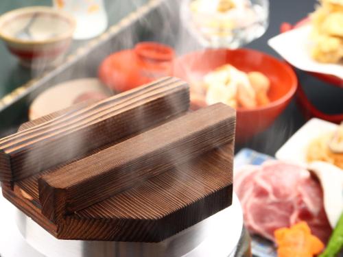 a close up of a wooden stand with meat and other foods at Bandai in Tokamachi