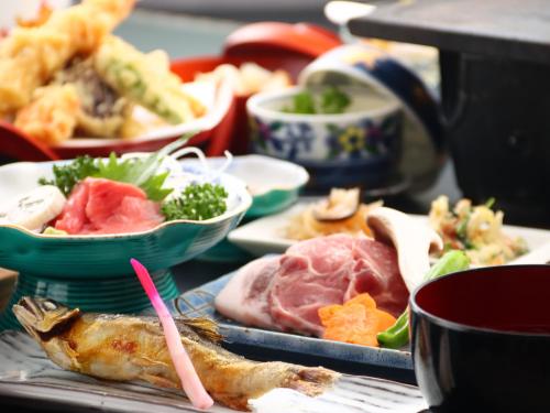 a table with plates of food and bowls of food at Bandai in Tokamachi
