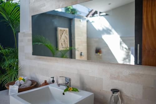 a bathroom with a sink and a mirror at Villa Coco Bali in Seminyak