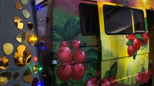 a food truck with a painting of apples on it at Urban Van Glamping Riga in Rīga