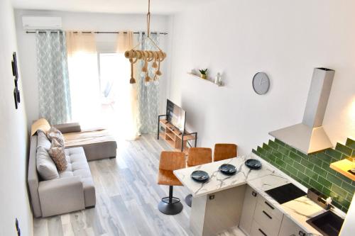 a living room with a couch and a table at Varonos Summer Residences in Siviri