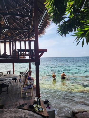 a group of people in the water at the beach at Tao Thong Villa 2 in Ko Tao